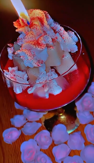 Whipped Rose Candle in a glass with red shimmer topping